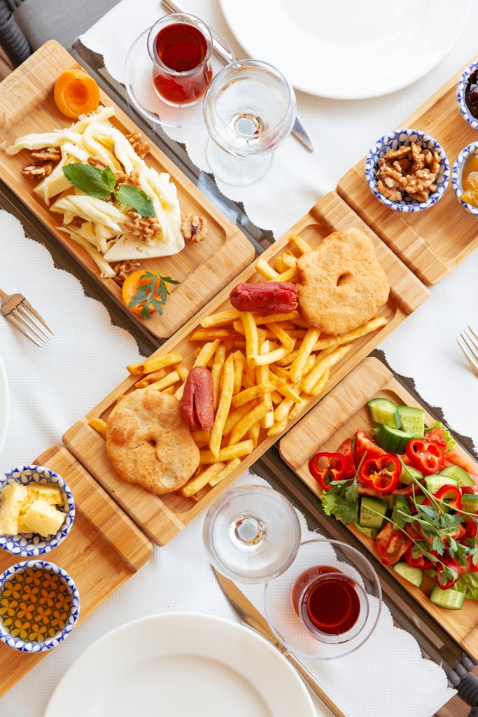 An inviting Mediterranean meal with various dishes on wooden boards, perfect for a vibrant dining experience.